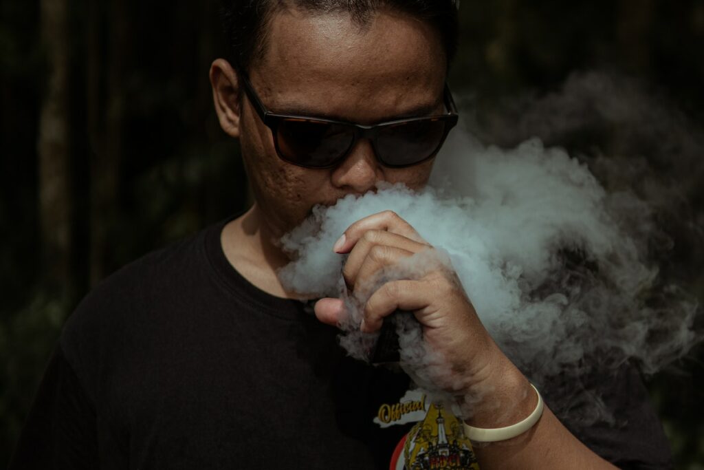 Photo of a man smoking a vape