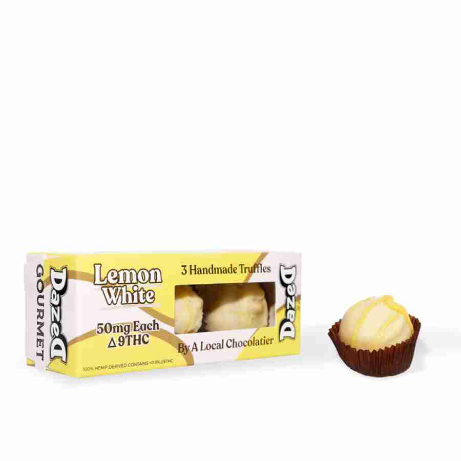 a box of lemon white next to a cupcake.