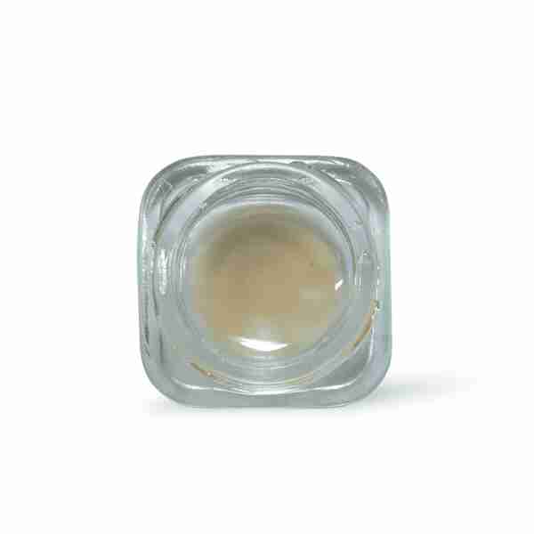 a clear square container filled with liquid on a white background.