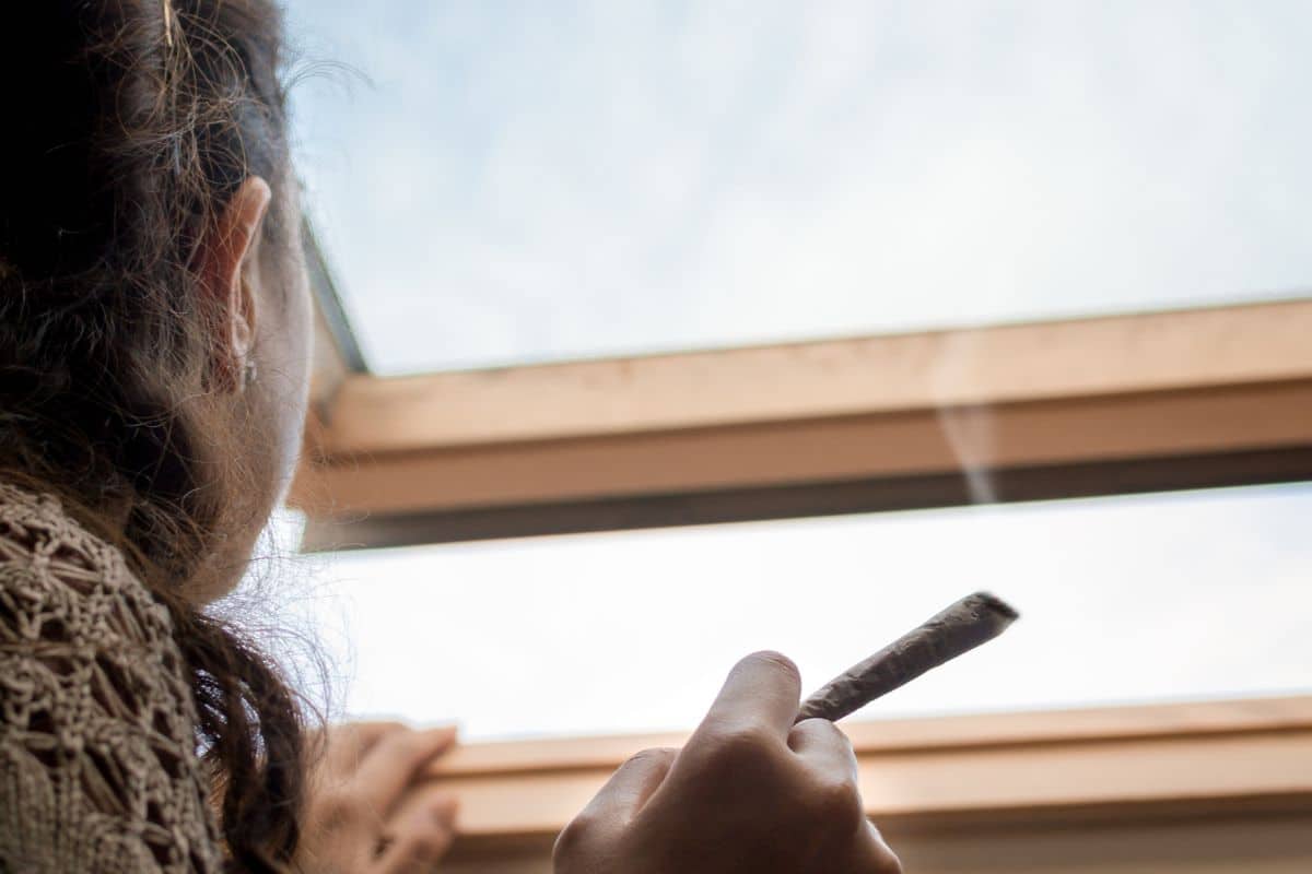 A woman smoking weed discreetly at home