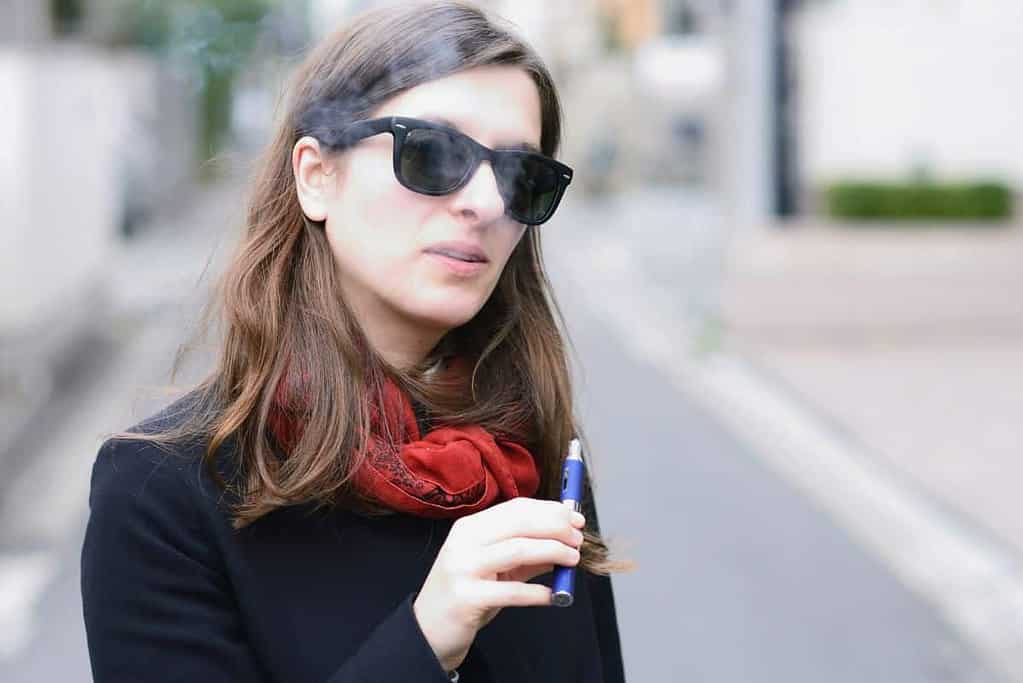 A woman holding second hand vaping device