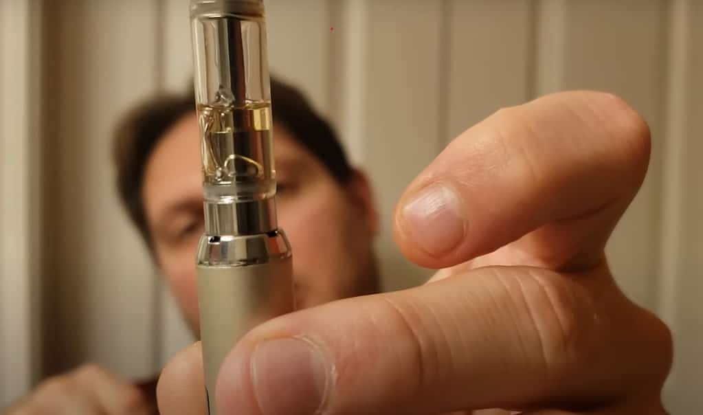Man showing air bubble formed in the cartridge of vape