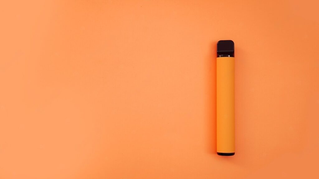 Orange disposable electronic cigarette on bright background