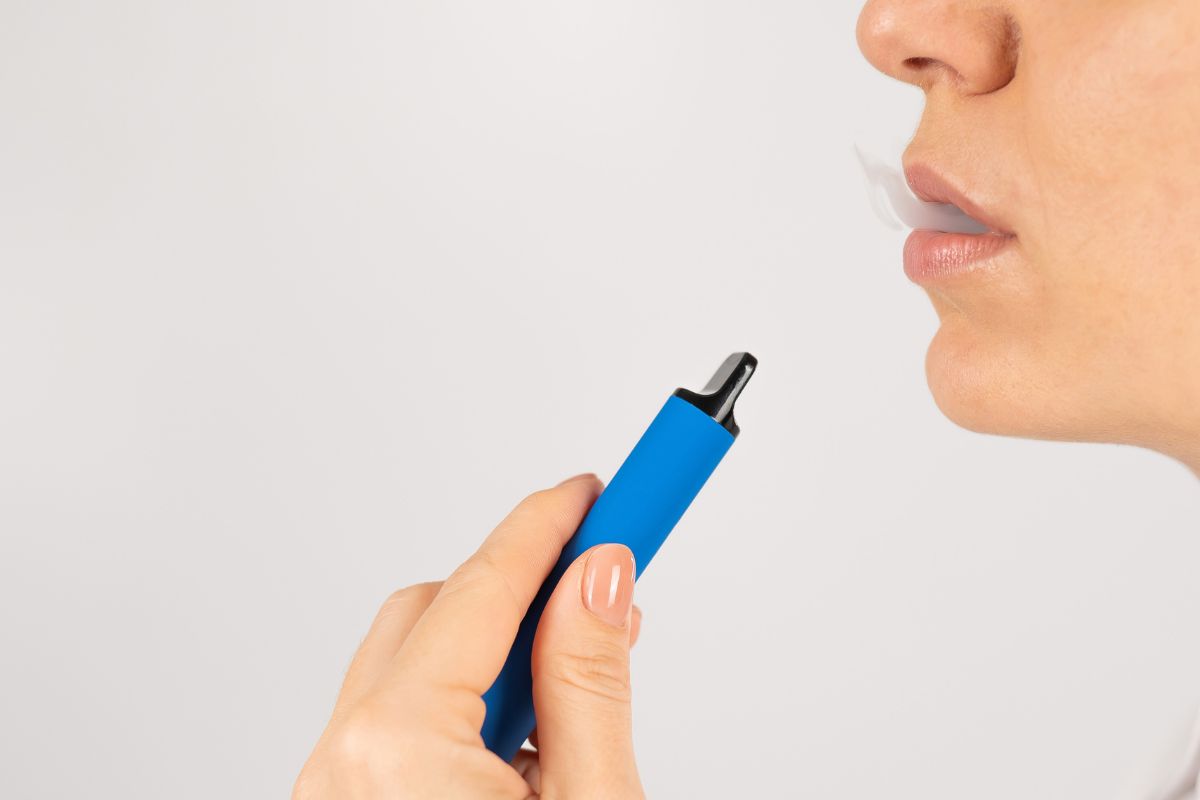 A woman taking a hit from a disposable vape