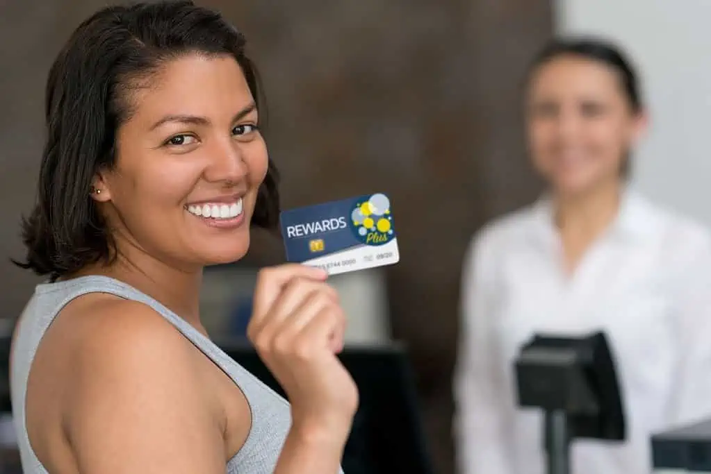 A lady holding dazed reward card