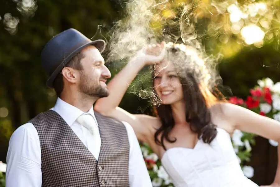 Vaping bride and groom pose for unique wedding photos