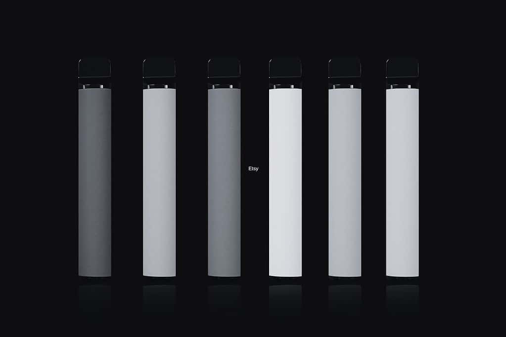 A group of black e cigarettes on a black background.