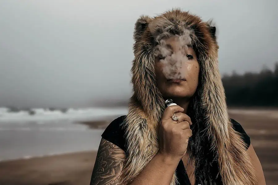 a man wearing a fur hat and holding a cigarette