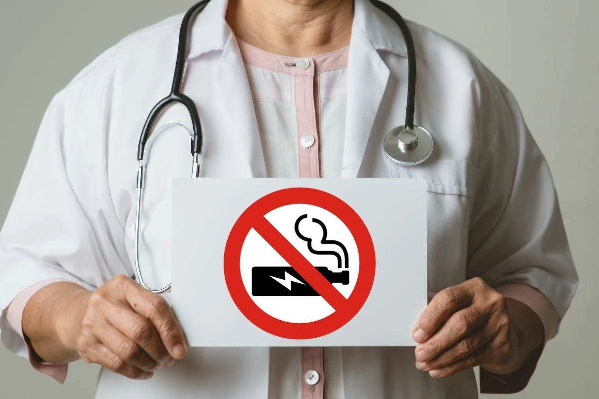 A doctor holding no vaping sign