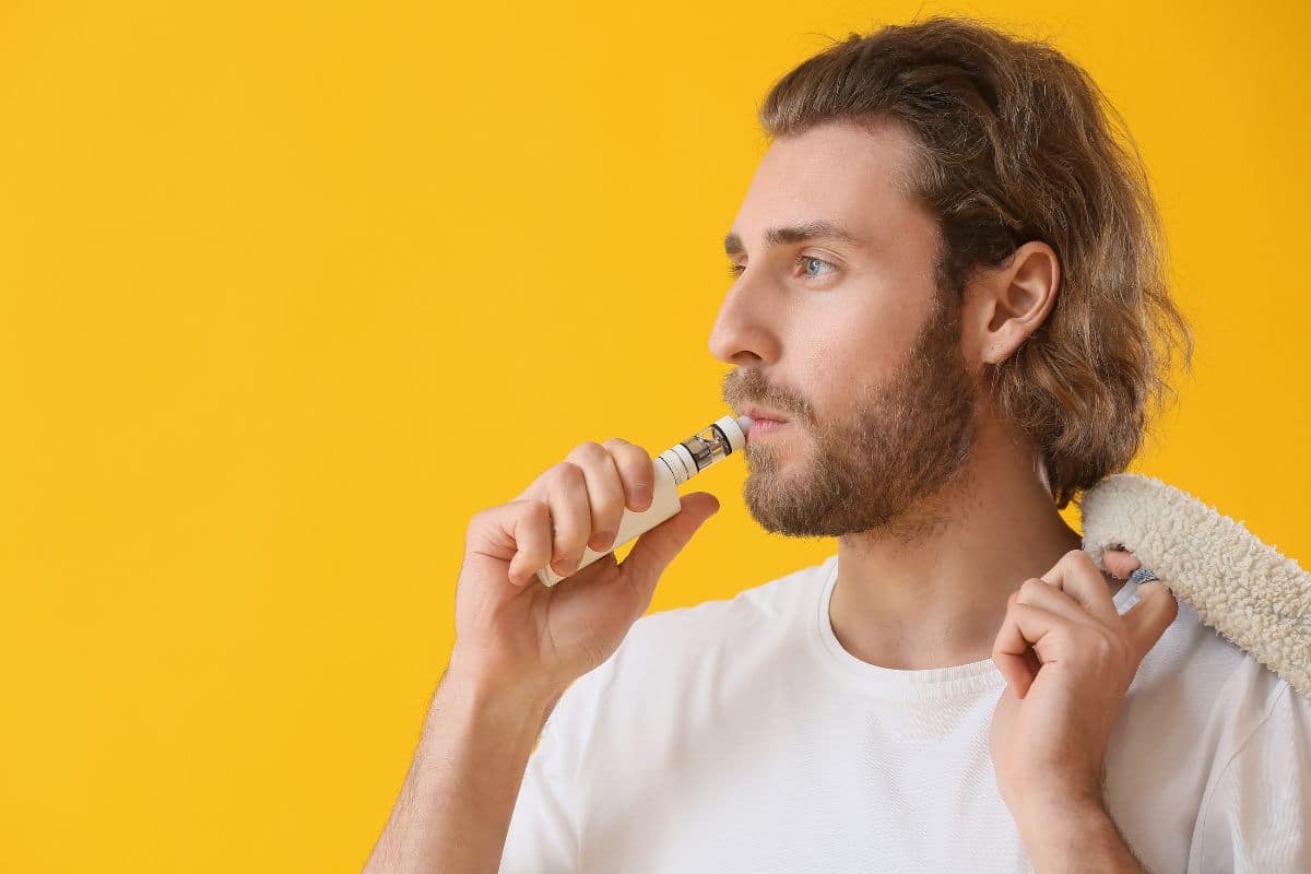 A guy vaping and thinking about vaping odor