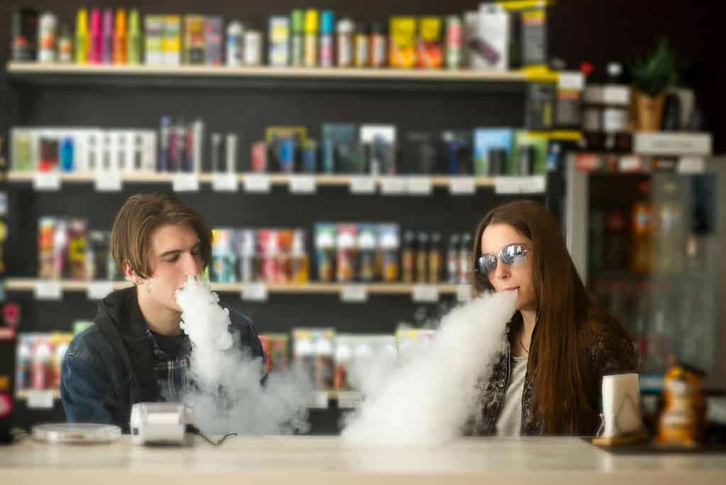 Young guy and a girl vaping