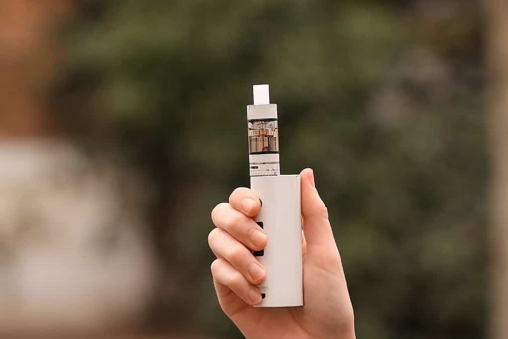 A woman's hand showcasing the compactness of a small electronic cigarette, one of the most durable vape mods available