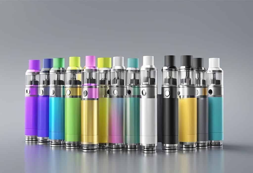 Colorful e cigarettes on a gray background, featuring both atomizer and vaporizer options
