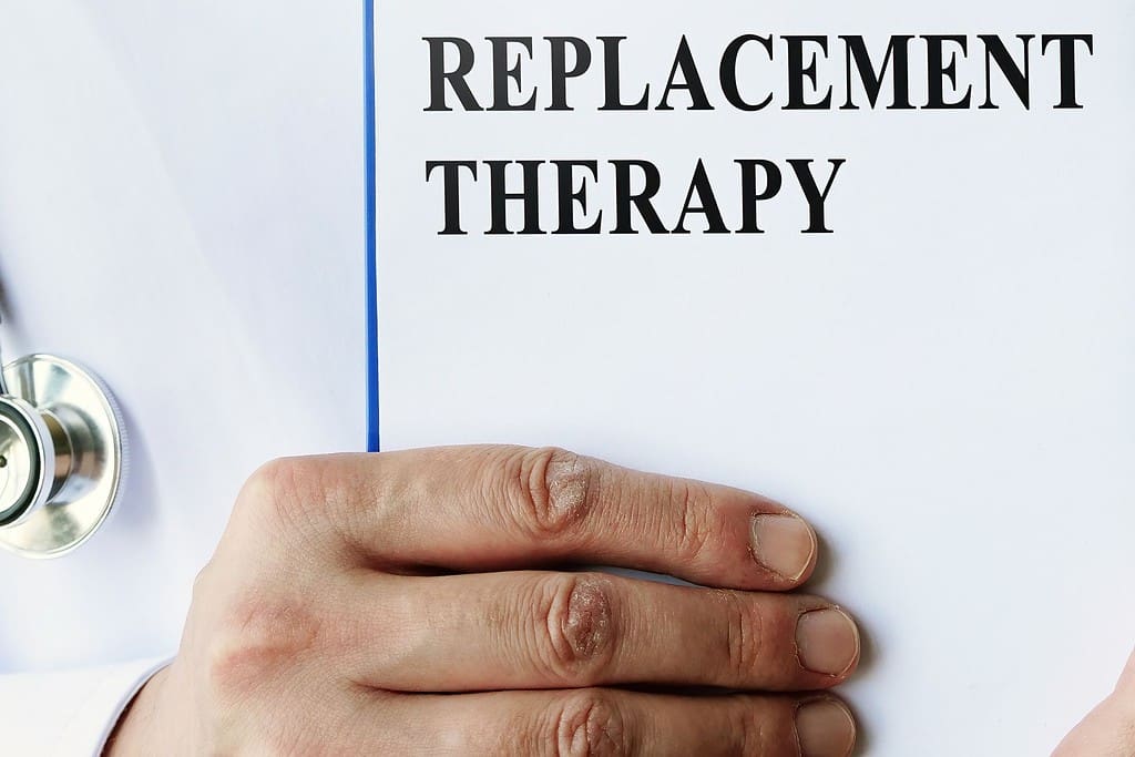 A doctor holding a paper with the words replacement therapy
