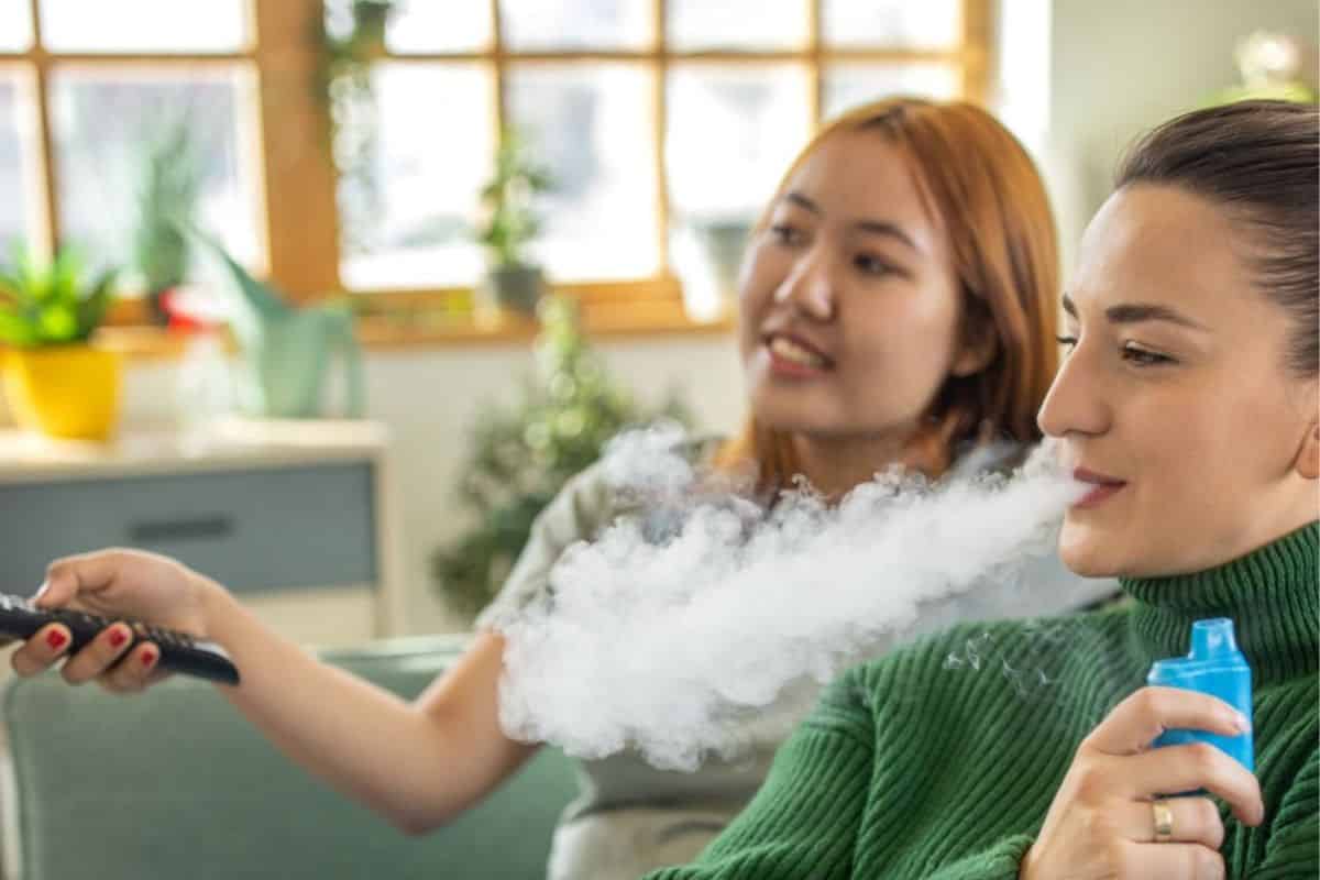 Are Raz Vapes Safe? Essential Health Insights and Risks 3 A lady vaping raz vape and watching movie with her friend