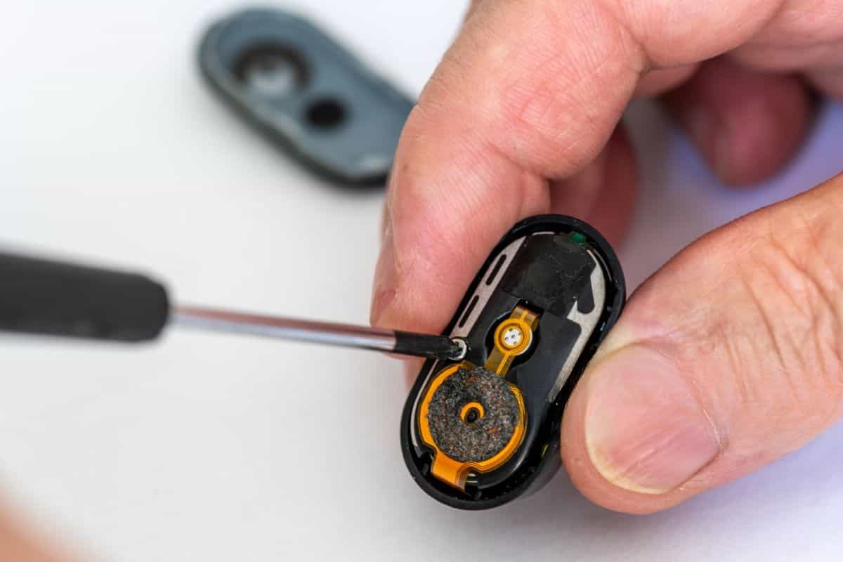 Are Raz Vapes Safe? Essential Health Insights and Risks 4 A person removing battery from raz vape carefully.